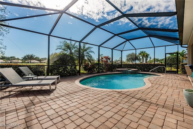 view of swimming pool with glass enclosure, a patio area, and an in ground hot tub