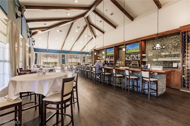 dining area featuring beamed ceiling, high vaulted ceiling, bar, and dark wood-type flooring