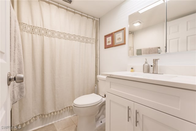 bathroom with tile patterned floors, curtained shower, vanity, and toilet