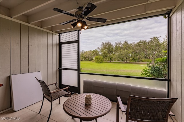 sunroom featuring ceiling fan