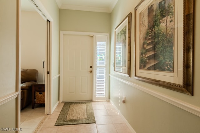 interior space with light tile patterned floors and ornamental molding