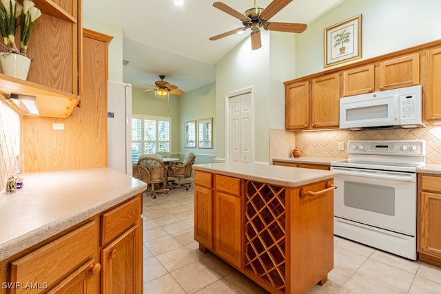 kitchen with decorative backsplash, light tile patterned floors, white appliances, and high vaulted ceiling