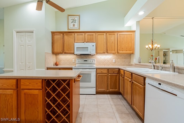 kitchen featuring sink, backsplash, pendant lighting, white appliances, and light tile patterned flooring