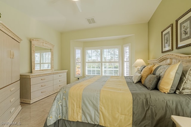 bedroom with light tile patterned floors, multiple windows, and ceiling fan