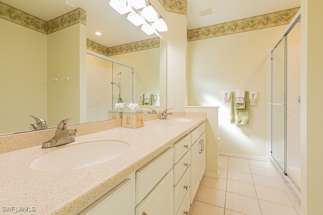 bathroom featuring a shower with door, vanity, and tile patterned flooring