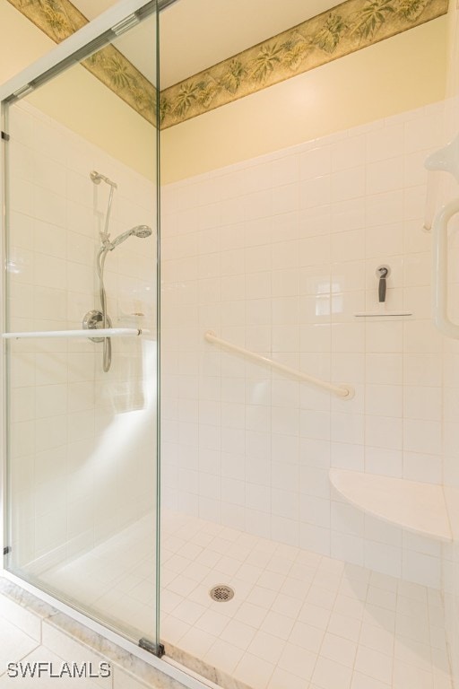 bathroom featuring a shower with shower door