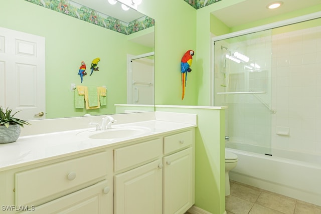 full bathroom featuring tile patterned floors, vanity, toilet, and tiled shower / bath combo