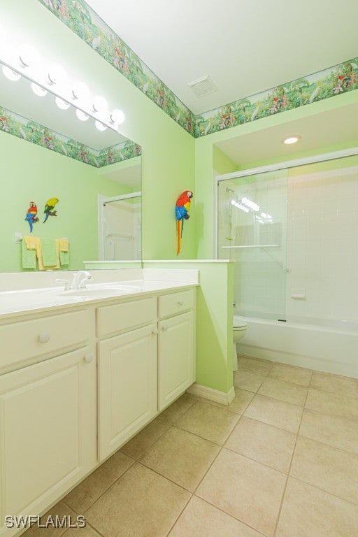 full bathroom with tile patterned flooring, vanity, toilet, and bath / shower combo with glass door