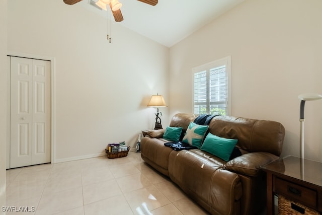 tiled living room featuring high vaulted ceiling and ceiling fan