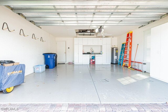 garage featuring a garage door opener and water heater