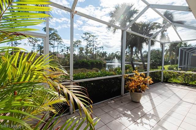 sunroom / solarium featuring a water view