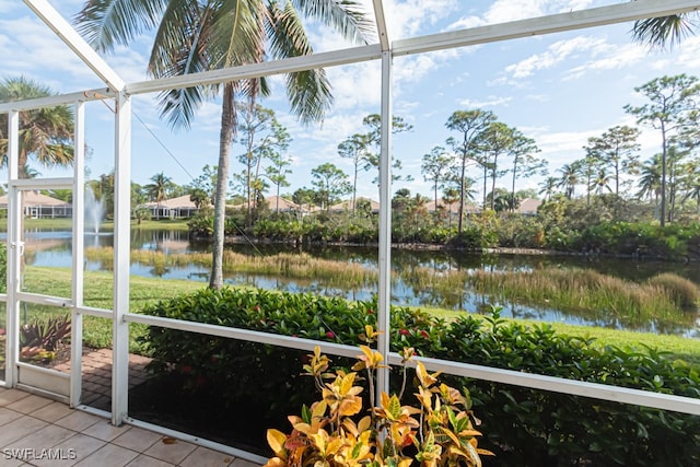 unfurnished sunroom featuring a water view