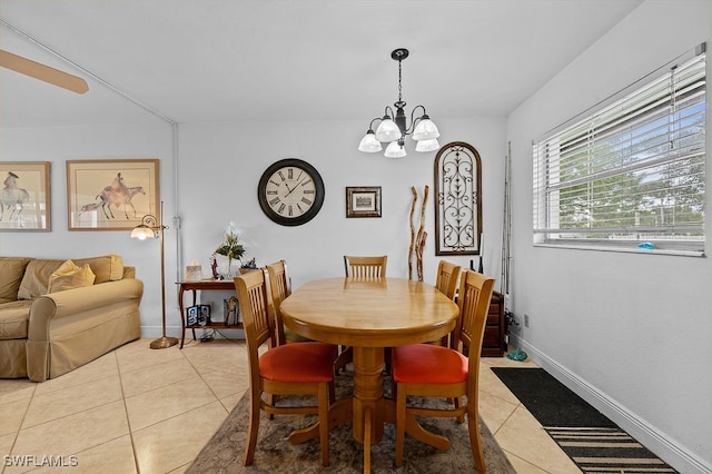 tiled dining area featuring a chandelier