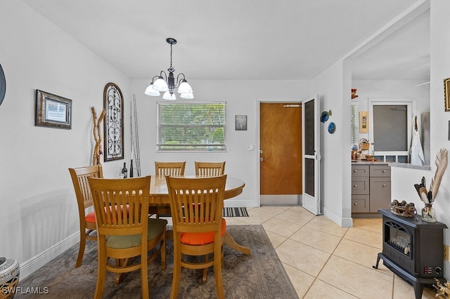 dining room featuring light tile patterned flooring and an inviting chandelier