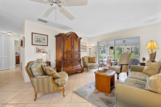 living room with ceiling fan and light tile patterned flooring