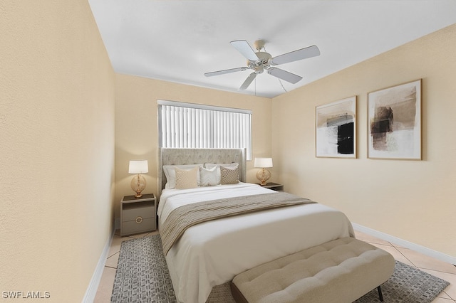 bedroom with ceiling fan and light tile patterned flooring