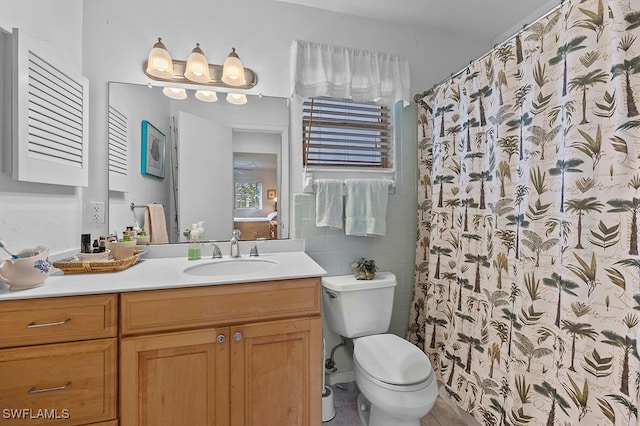 bathroom with tile patterned floors, curtained shower, vanity, and toilet