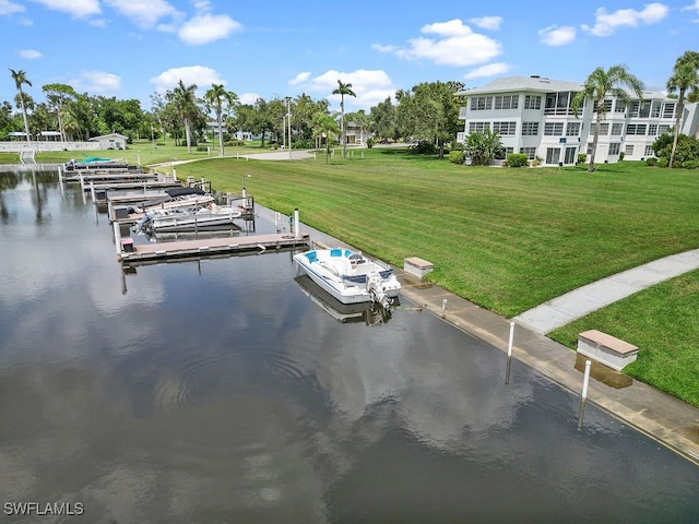 dock area with a water view and a lawn