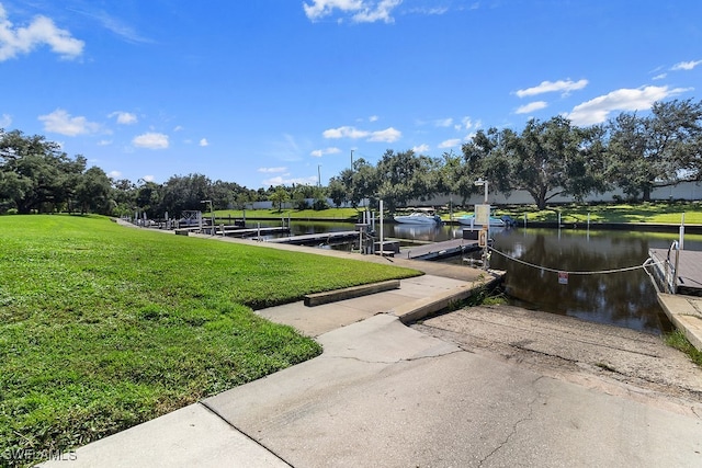 dock area featuring a water view and a lawn