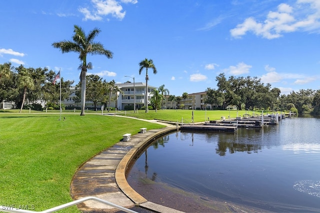 surrounding community featuring a yard, a water view, and a boat dock