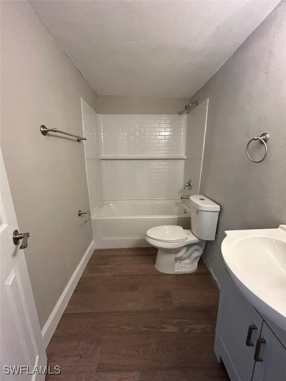 full bathroom featuring hardwood / wood-style floors, vanity, toilet, and tiled shower / bath combo