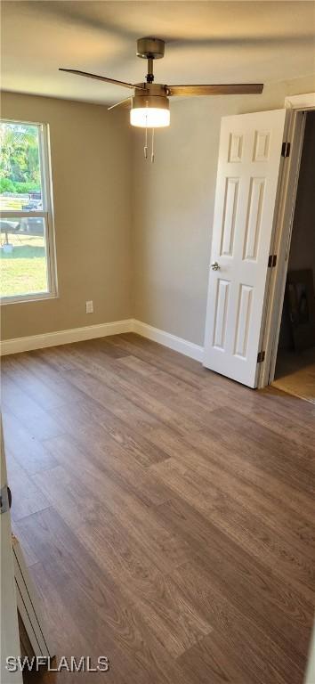 spare room featuring wood-type flooring and ceiling fan