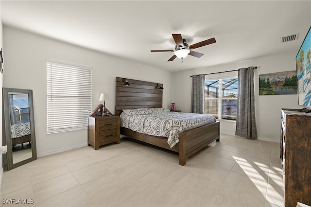 bedroom featuring light tile patterned floors, baseboards, visible vents, and ceiling fan