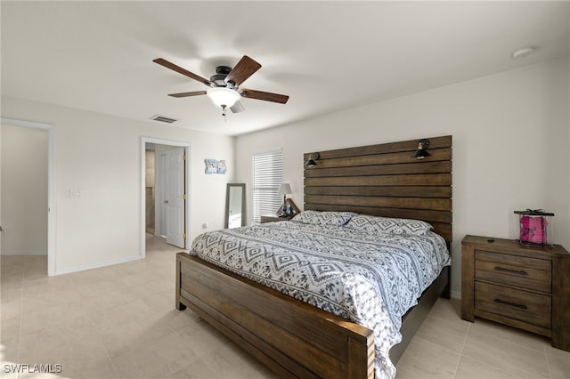 bedroom featuring ceiling fan, light tile patterned floors, visible vents, and baseboards