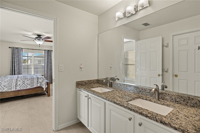 ensuite bathroom with a ceiling fan, tile patterned flooring, visible vents, and a sink