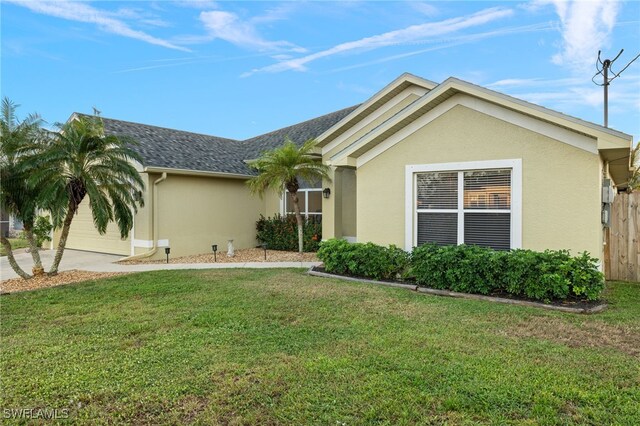 ranch-style home featuring a garage and a front yard