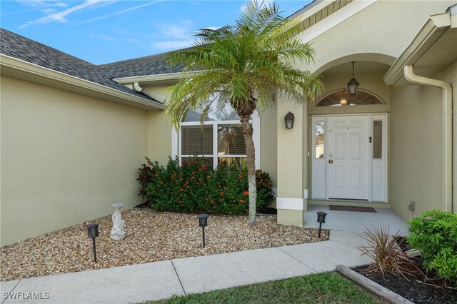 3530 NE 12th Ct, Cape Coral, FL 33909 - entrance to property featuring stucco siding and roof with shingles