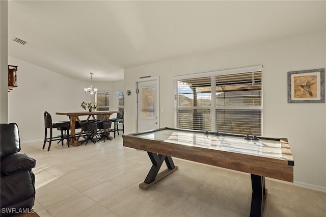 game room featuring baseboards, visible vents, and a chandelier