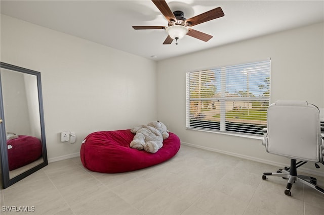 office area featuring tile patterned flooring, a ceiling fan, and baseboards