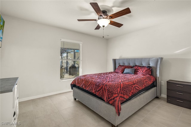 bedroom with light tile patterned floors, a ceiling fan, and baseboards