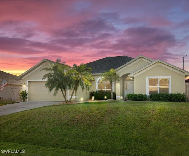 single story home featuring a front yard, concrete driveway, and stucco siding