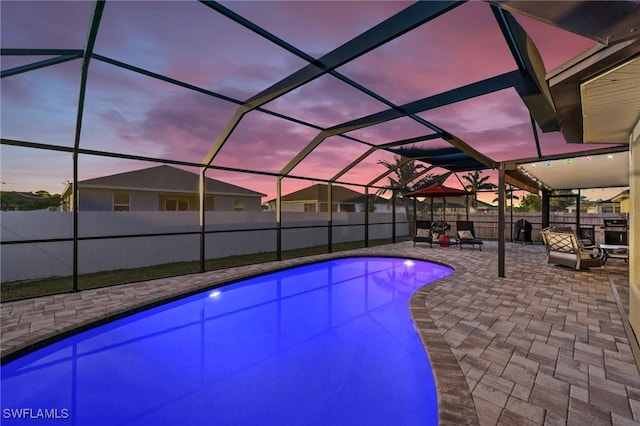 view of swimming pool featuring a patio, a fenced backyard, a fenced in pool, and a lanai