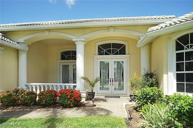 view of exterior entry featuring french doors