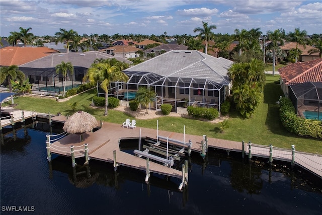 dock area with a lanai and a water view