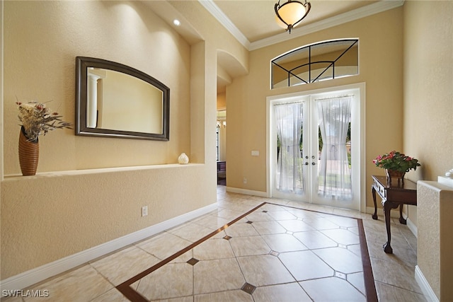 foyer entrance with crown molding and french doors