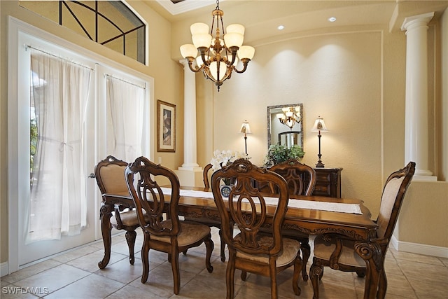 dining room featuring light tile patterned floors, decorative columns, and a notable chandelier