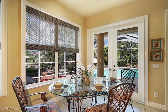 dining space featuring french doors and light tile patterned flooring