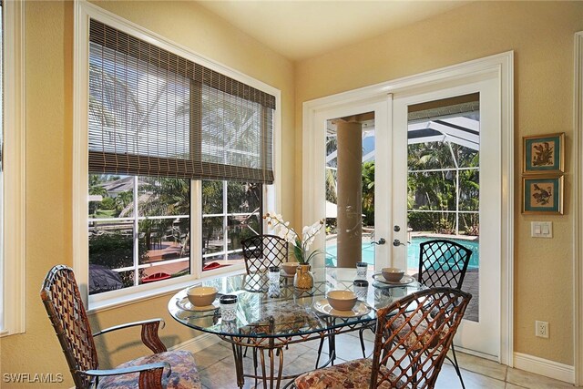 4126 SW 27th Ave, Cape Coral, FL 33914 - dining space with french doors, tile patterned flooring, and baseboards