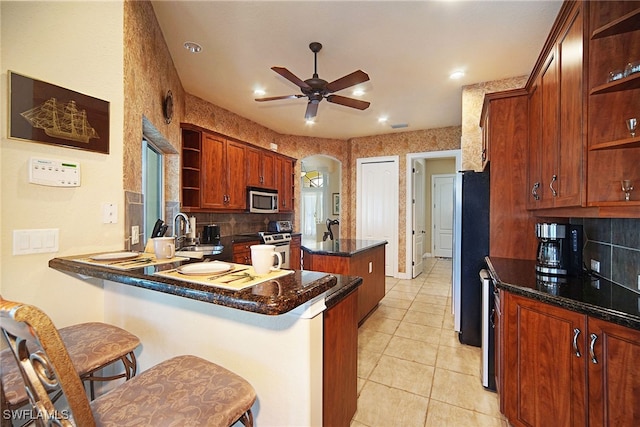 4126 SW 27th Ave, Cape Coral, FL 33914 - kitchen with open shelves, stainless steel appliances, a sink, a kitchen island, and recessed lighting
