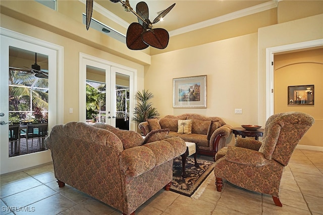 living room with tile patterned flooring, french doors, ceiling fan, and ornamental molding