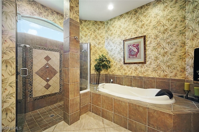 bathroom with tile patterned flooring and shower with separate bathtub