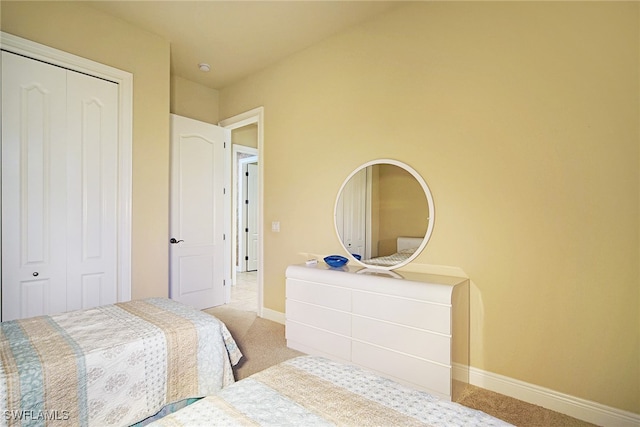 carpeted bedroom featuring a closet