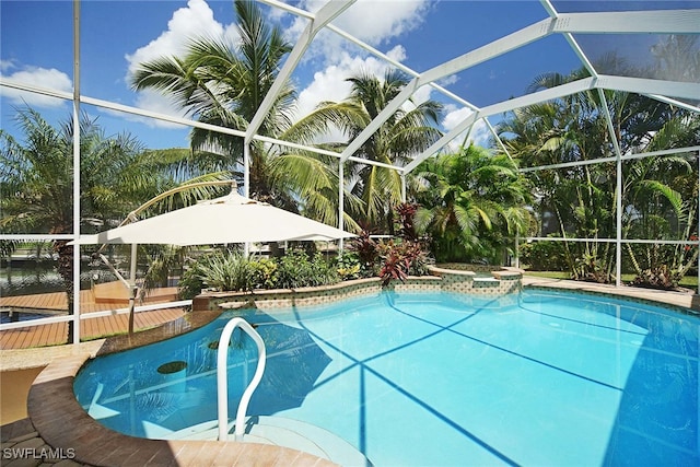 view of pool with a lanai and a hot tub