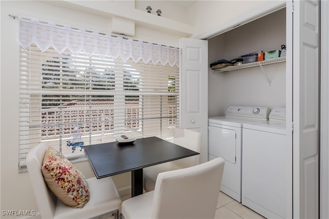 dining room with light tile patterned flooring and washing machine and clothes dryer