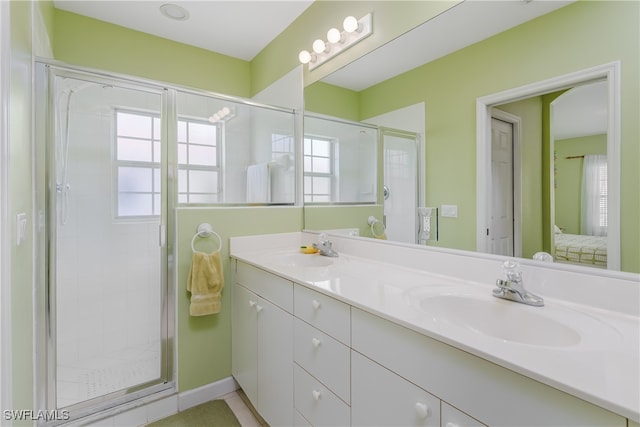 bathroom with vanity and a shower with shower door