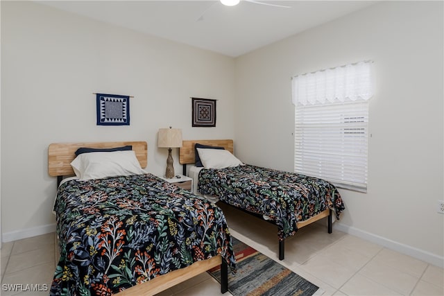 tiled bedroom featuring ceiling fan